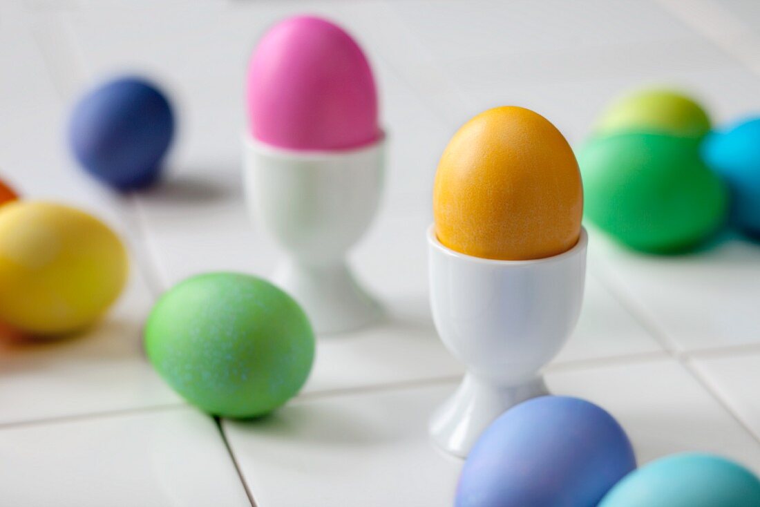 Coloured Easter eggs in egg cups