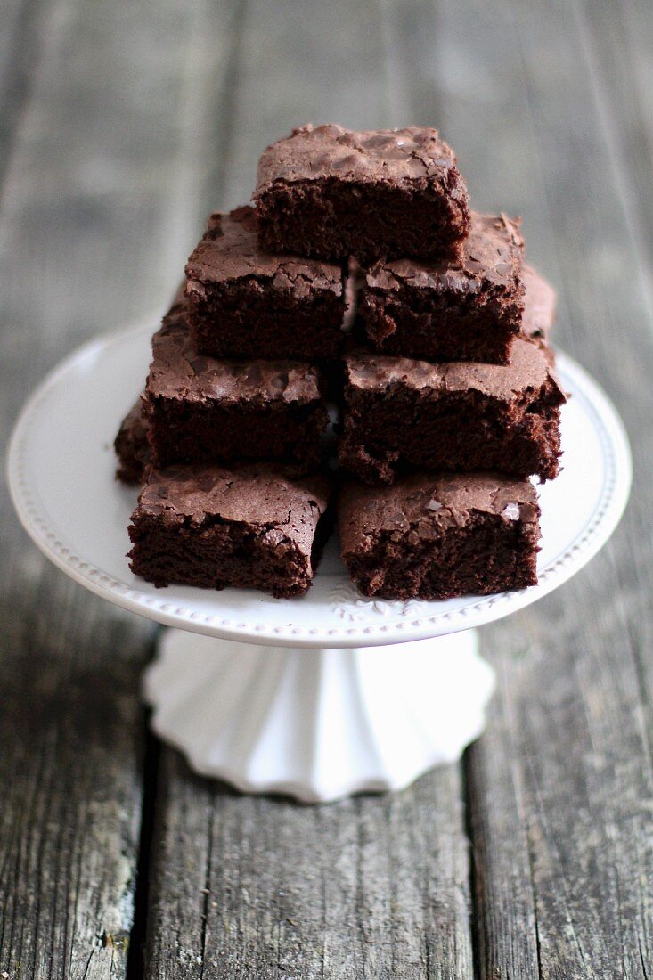 A stack of brownies on a cake stand