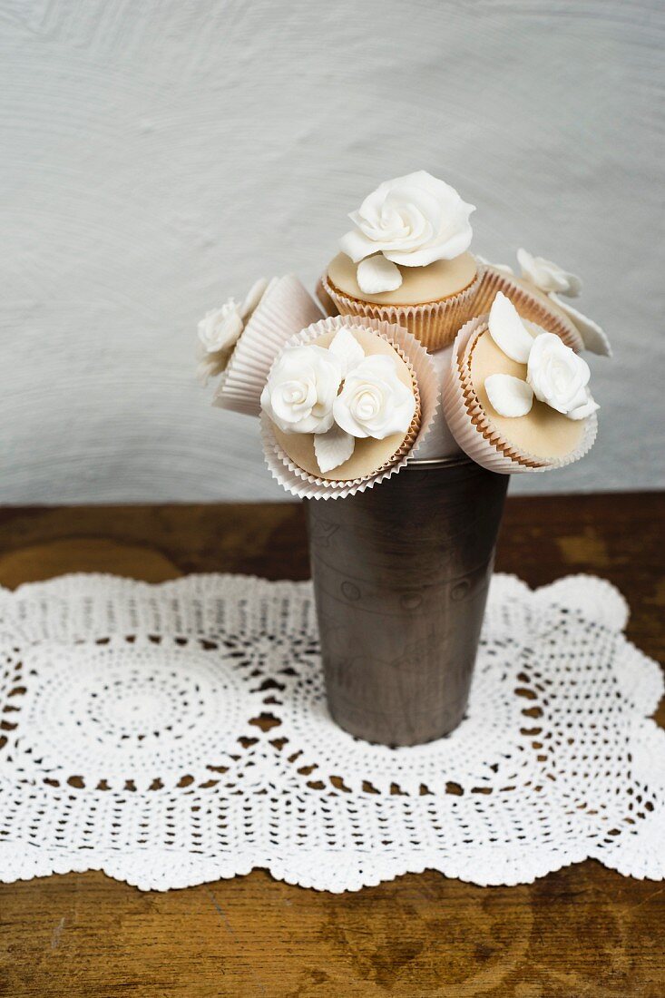 A bunch of cupcake flowers decorated with sugar flowers