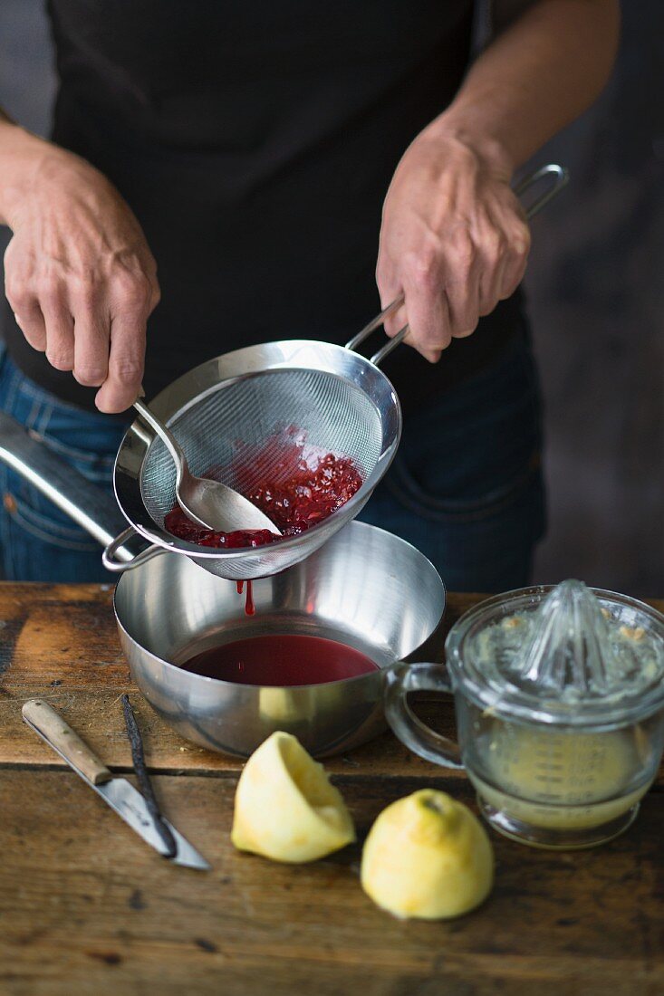 Pushing raspberries through a sieve