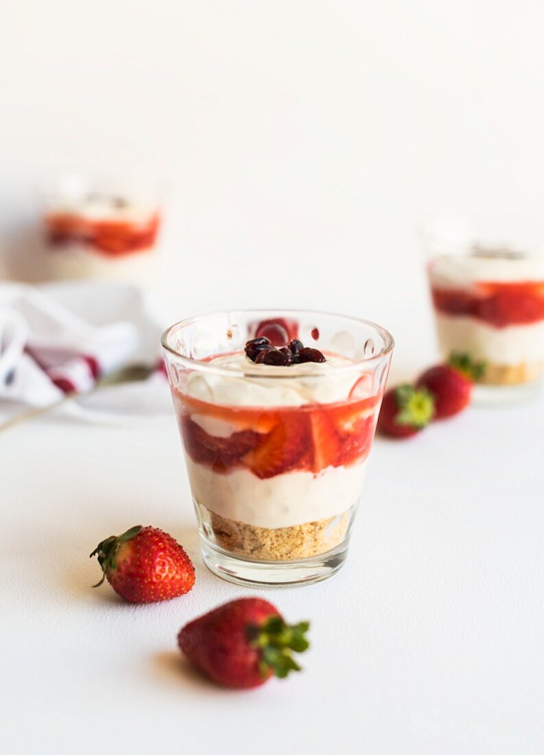 Cheesecake and strawberry layered desserts in glasses