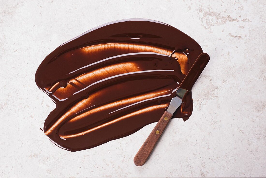 Liquid chocolate spread with a knife