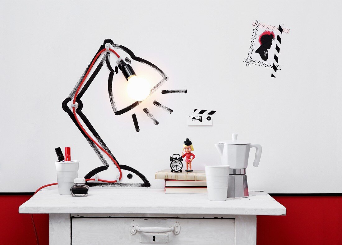 DIY light sculpture on white, vintage chest of drawers - lamp socket on red cable attached to wall inside table lamp painted on wall