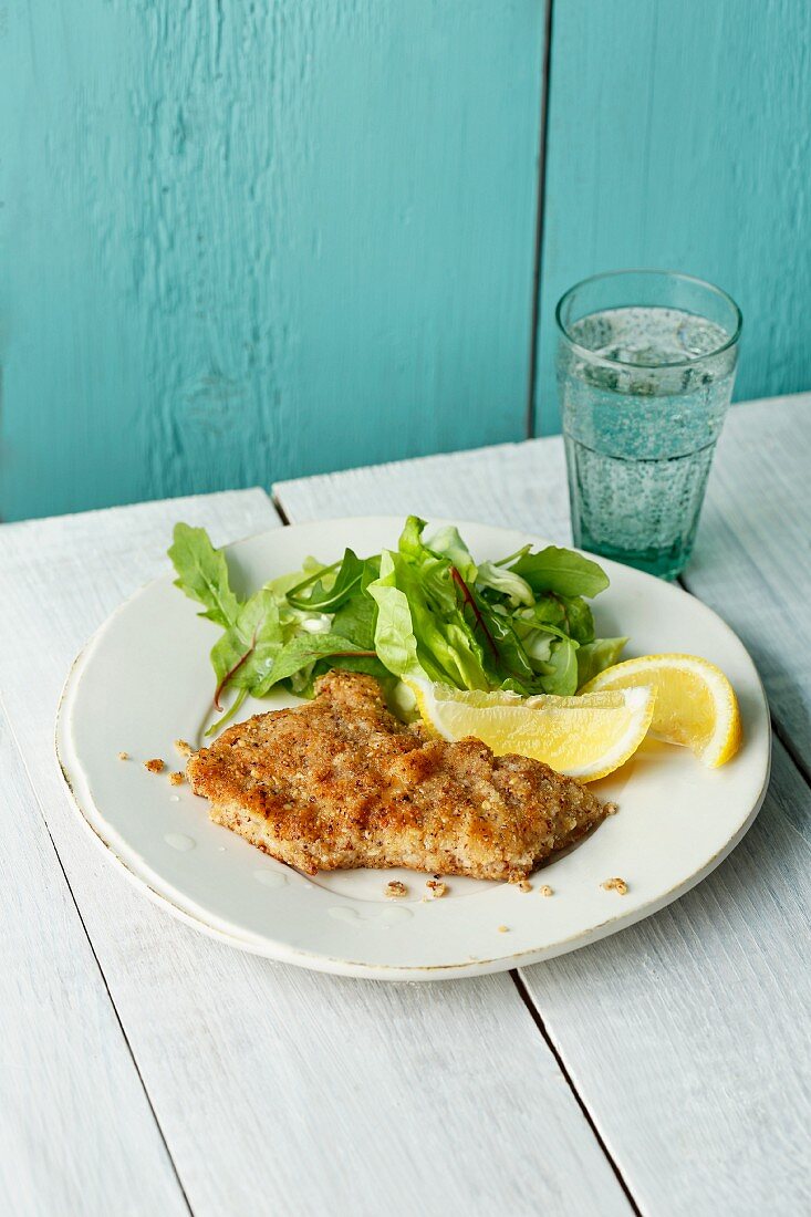 Veal escalope with a hazelnut crust served with young lettuce leaves