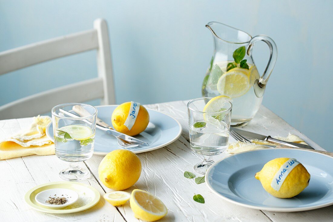 Table laid with lemons and lemon water