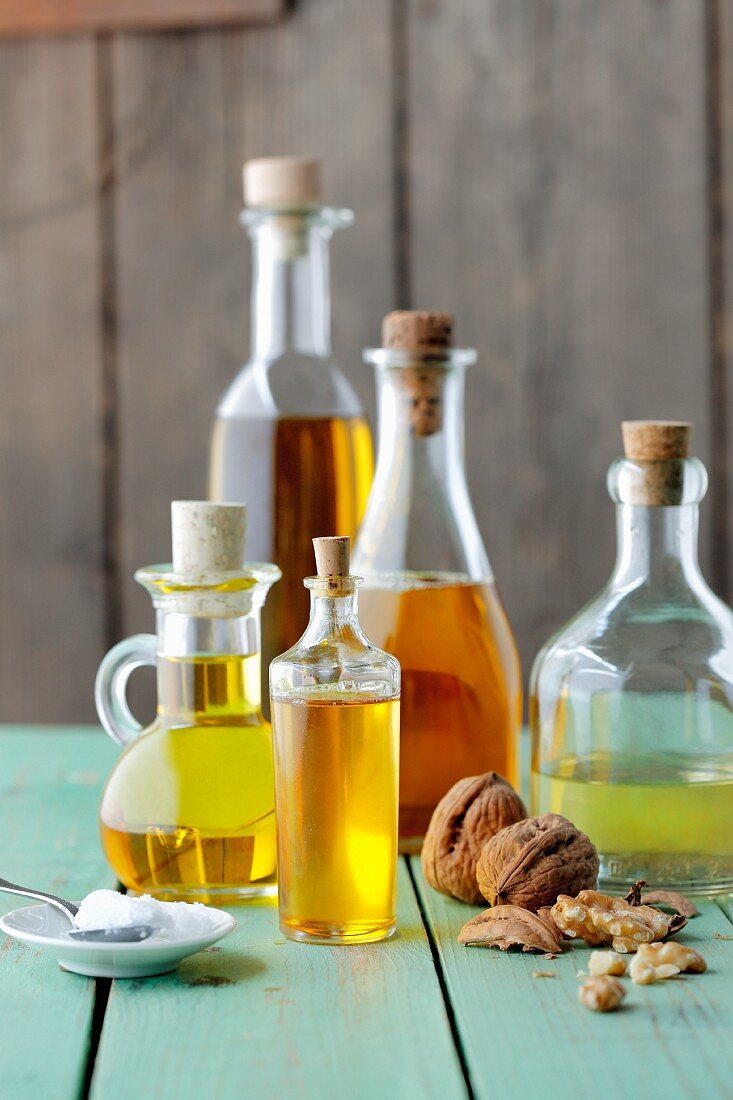 Various bottles of oil and walnuts