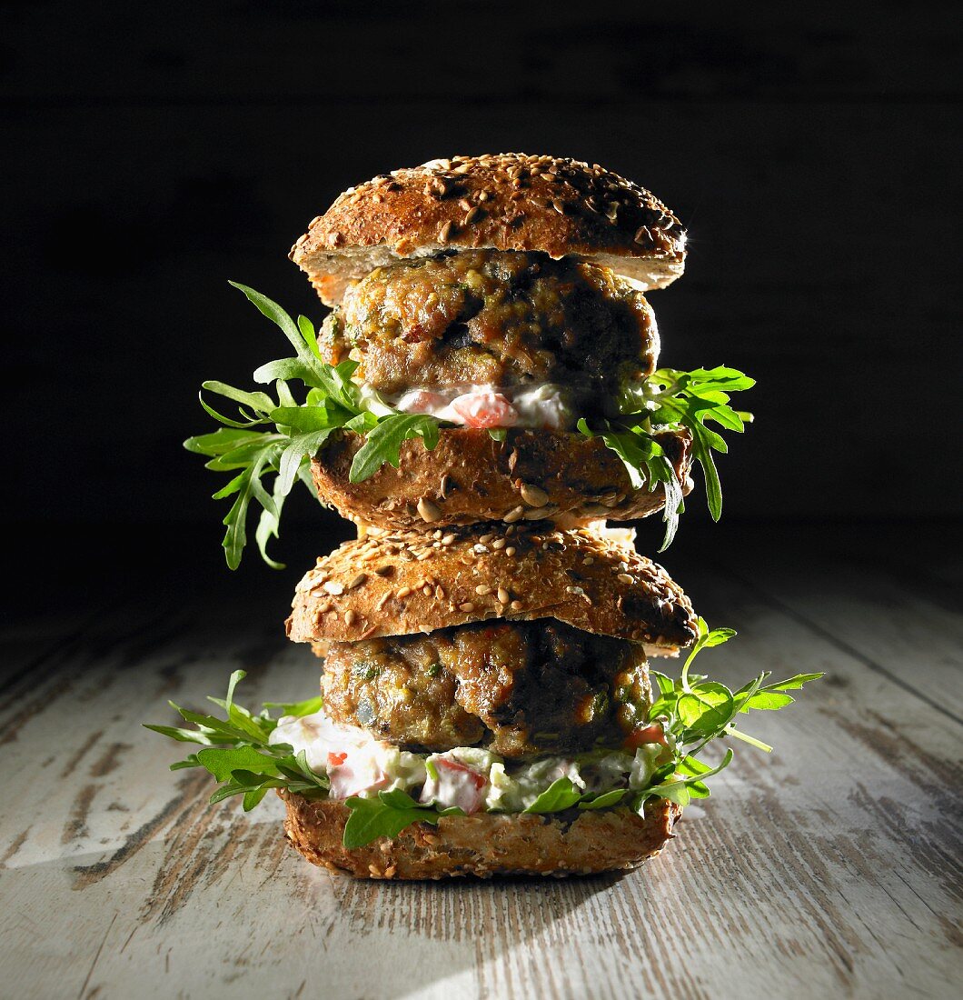 A stack of lamb burgers with rocket