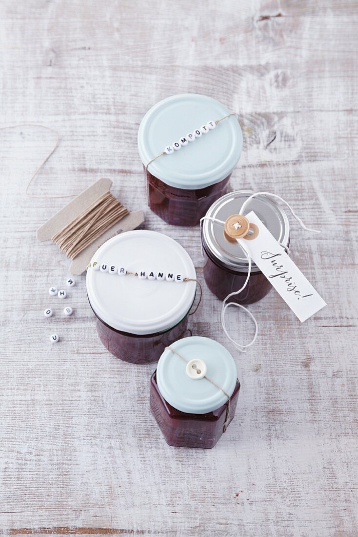 Jars of jam decorated with letter beads