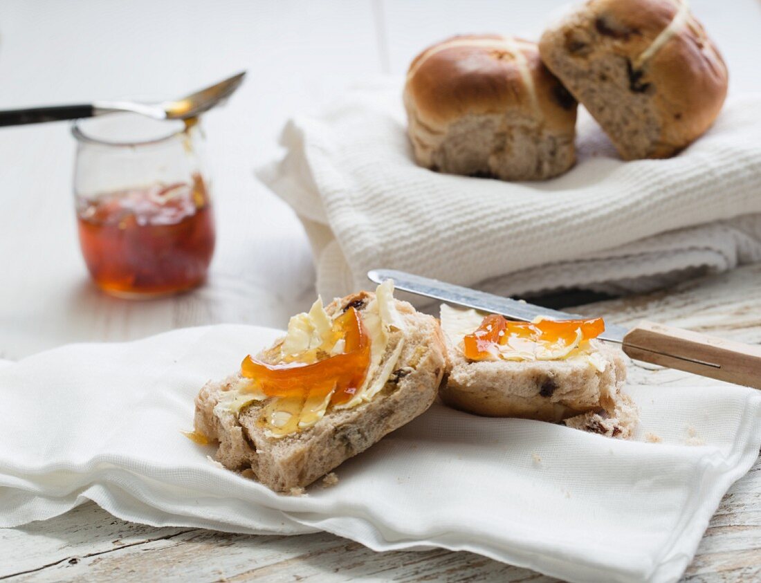 Hot cross buns with butter and marmalade