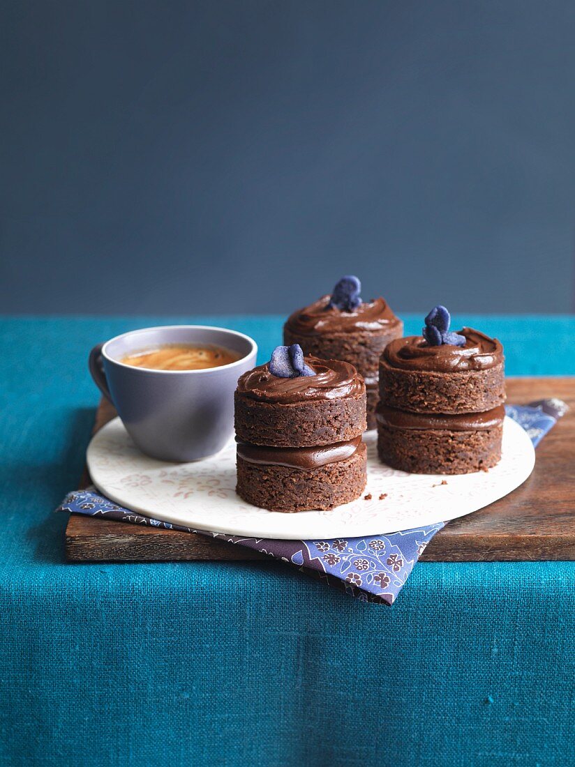 chocolate fudge cakes with candied violets and coffee