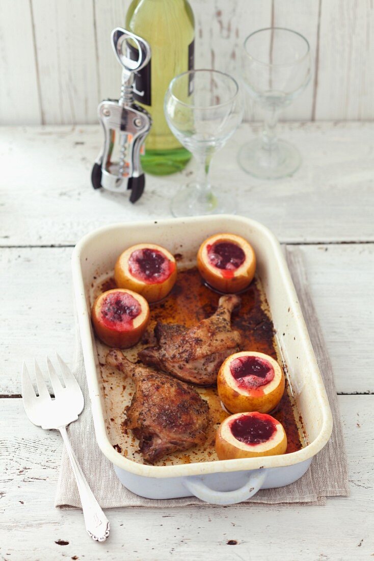 Roasted duck legs with apples filled with cranberries
