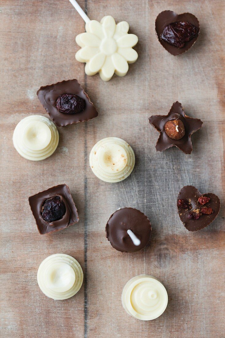Chocolates on stick with homemade pralines with dried fruits
