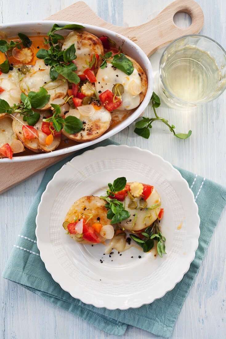 Baked potatoes with raclette cheese and tomato salsa