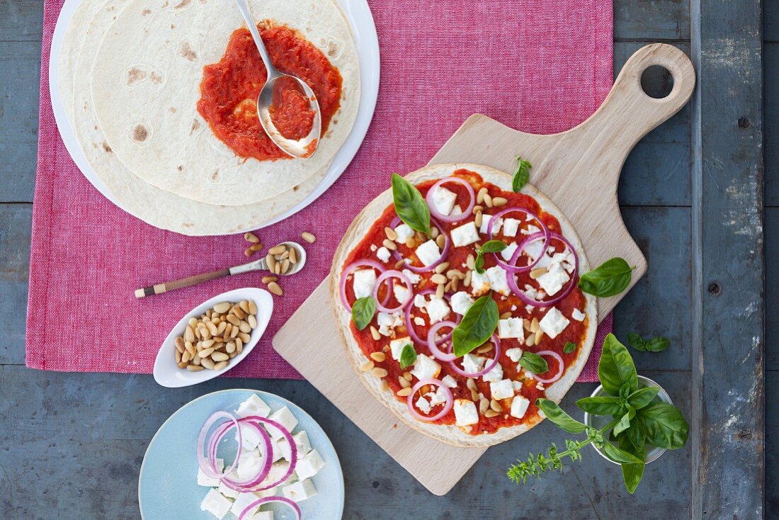 Vegetarian feta pizza with ajvar and pine nuts