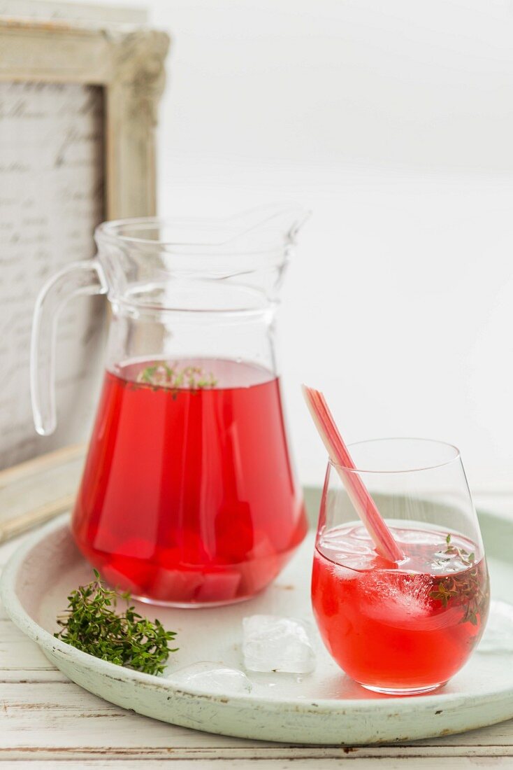 Rhubarb iced tea in a glass and a jug