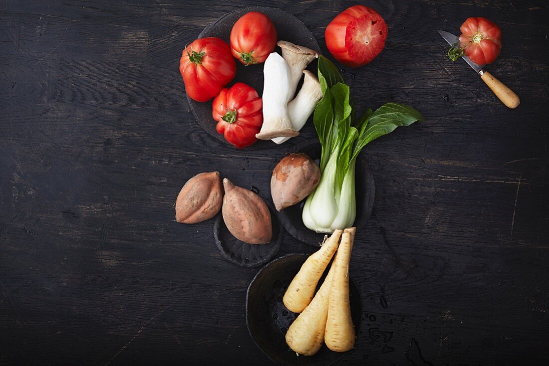 An arrangement of vegetables on a dark surface