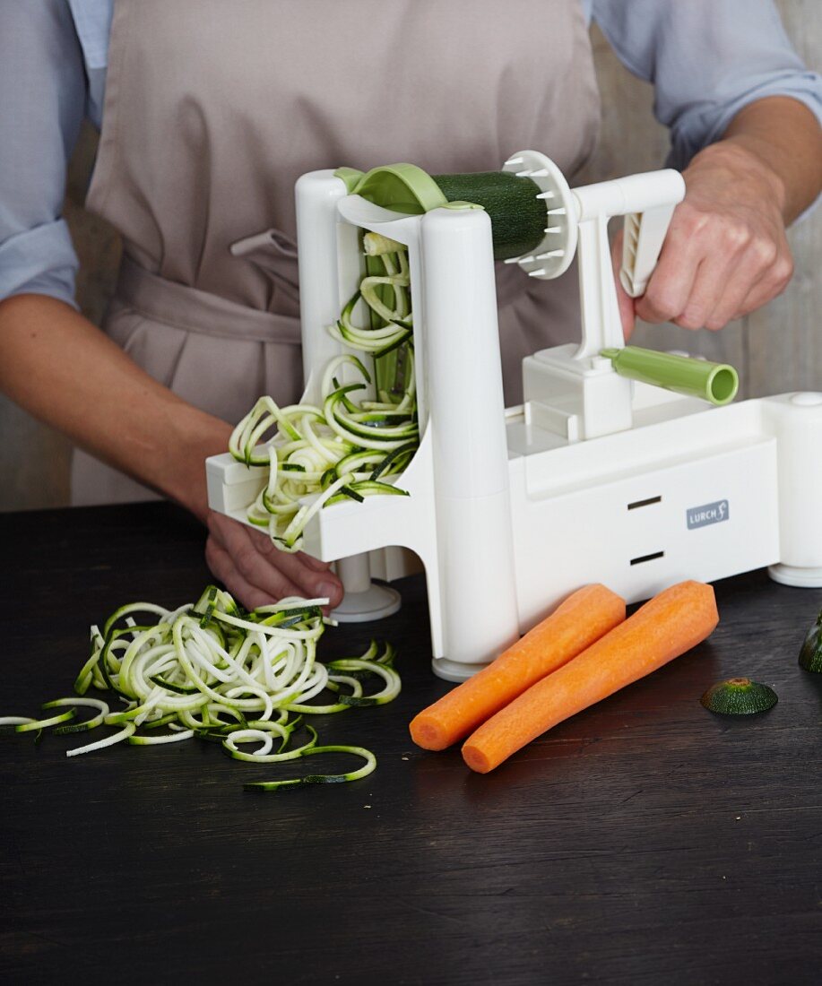 Vegetable noodles being made with a spiral cutter