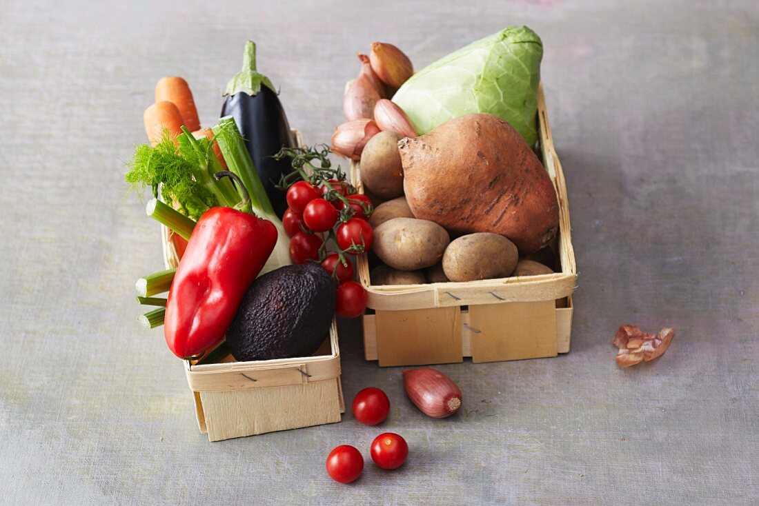 An arrangement of various vegetables in wooden baskets