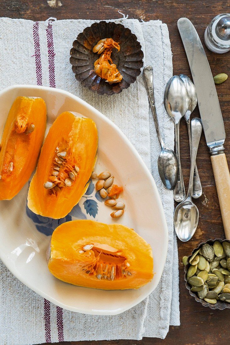 Pumpkin wedges on a plate with pumpkin seeds