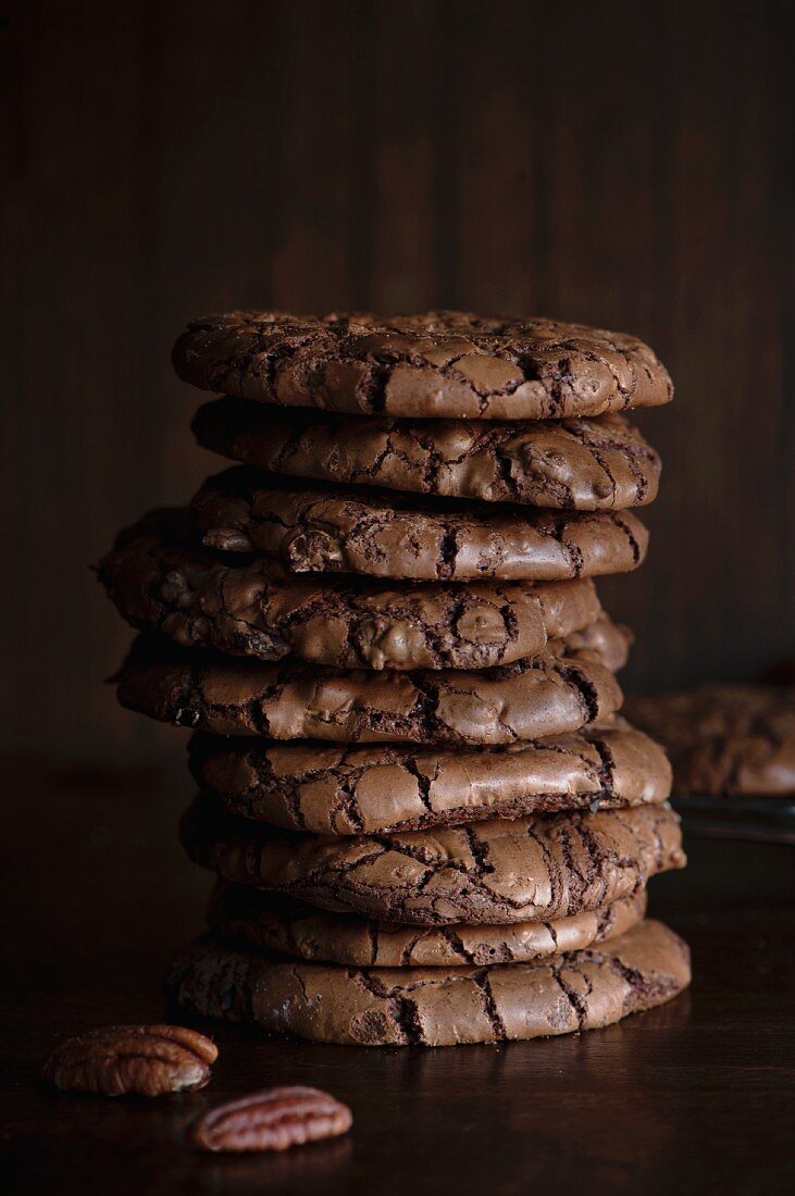 A stack of chocolate and pecan nut cookies