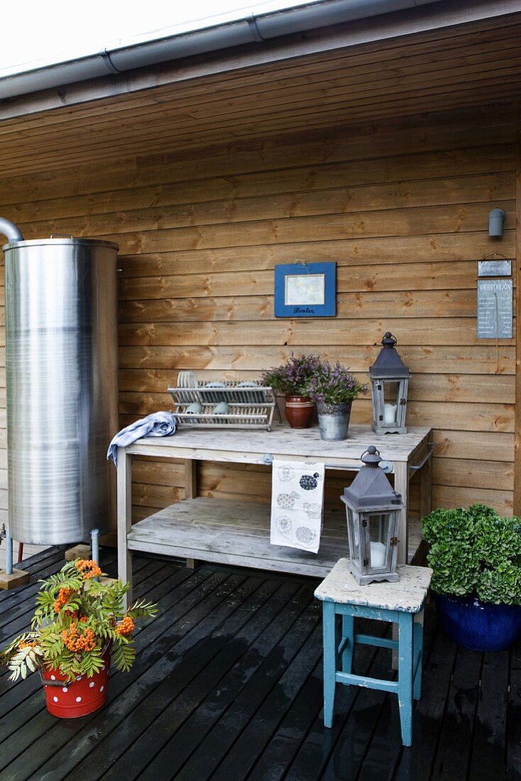 Wooden dresser on terrace against wood-clad façade