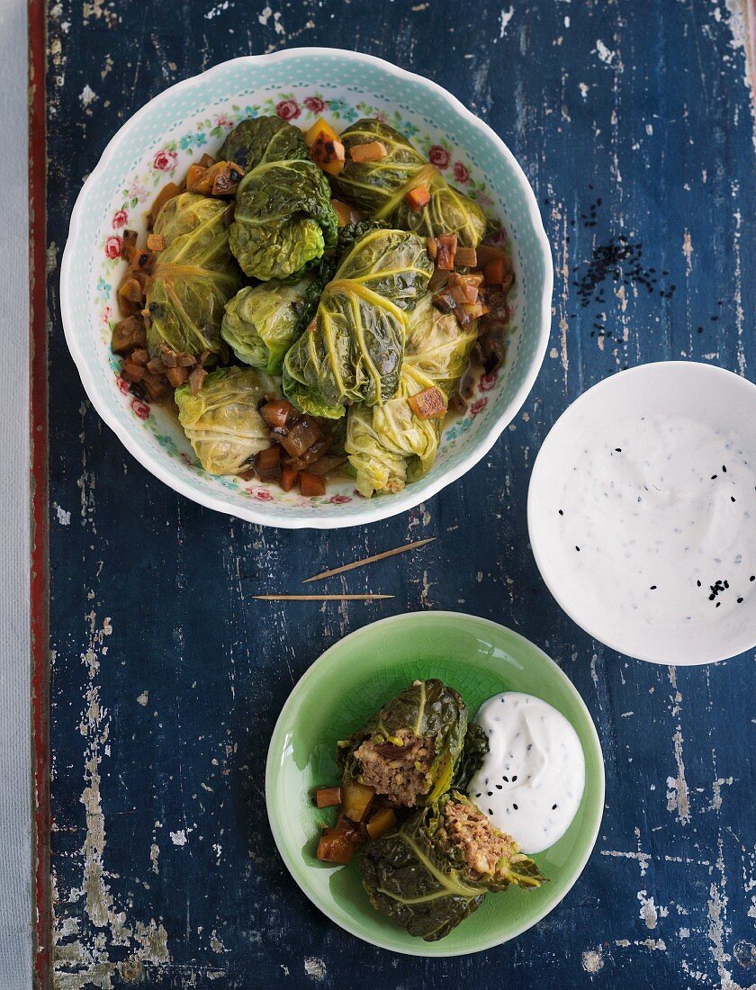 Savoy cabbage roulade filled with rice and minced meat on a blue wooden table