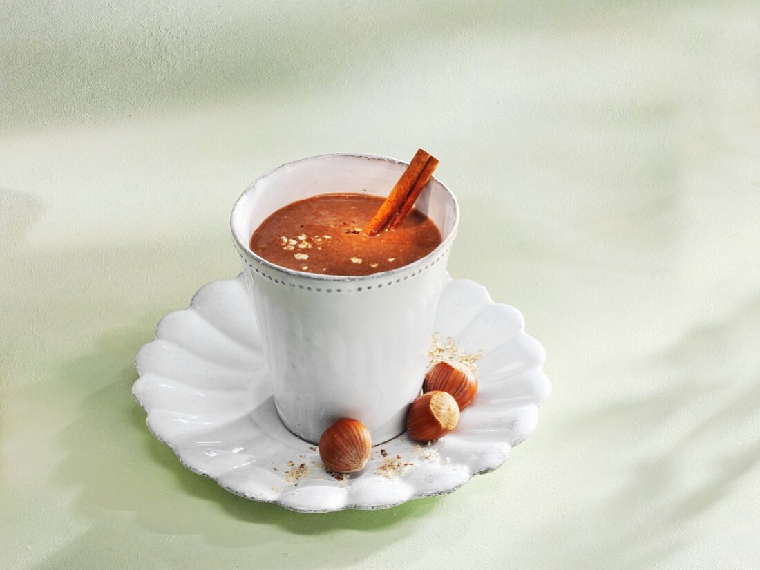 A chocolate and banana smoothie with hazelnuts and cinnamon