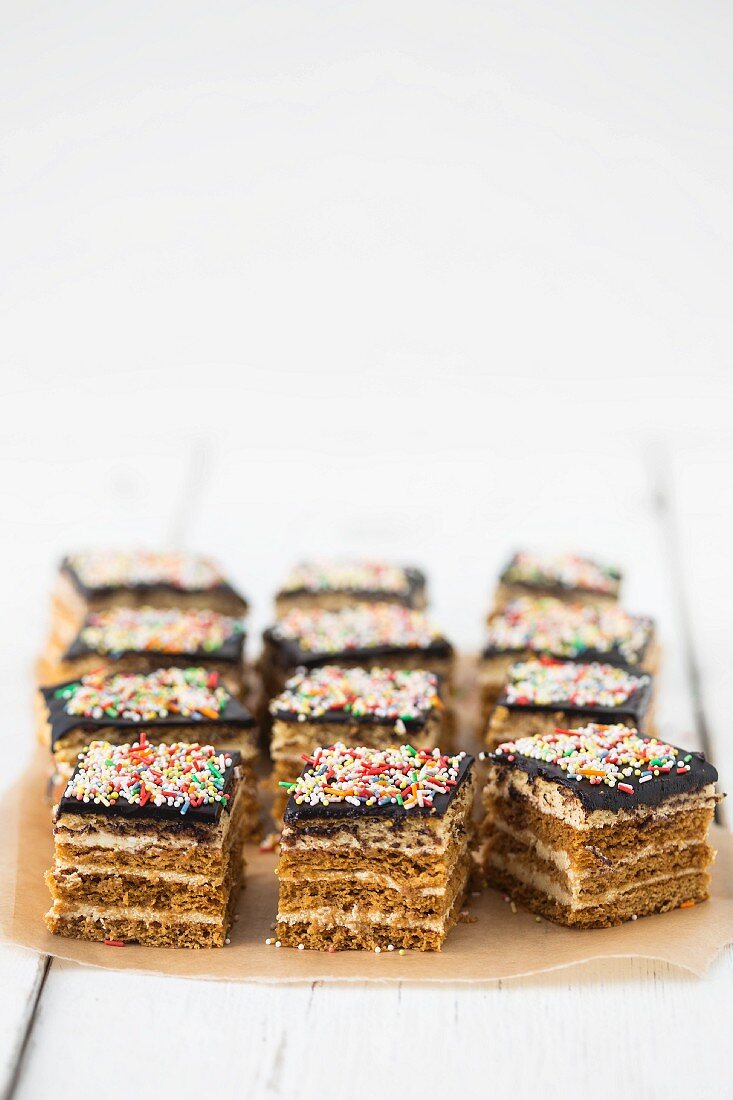 Layer cake with honey cream, ganache and colourful sugar sprinkles