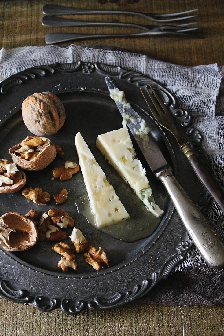 Roquefort and walnuts on a pewter plate