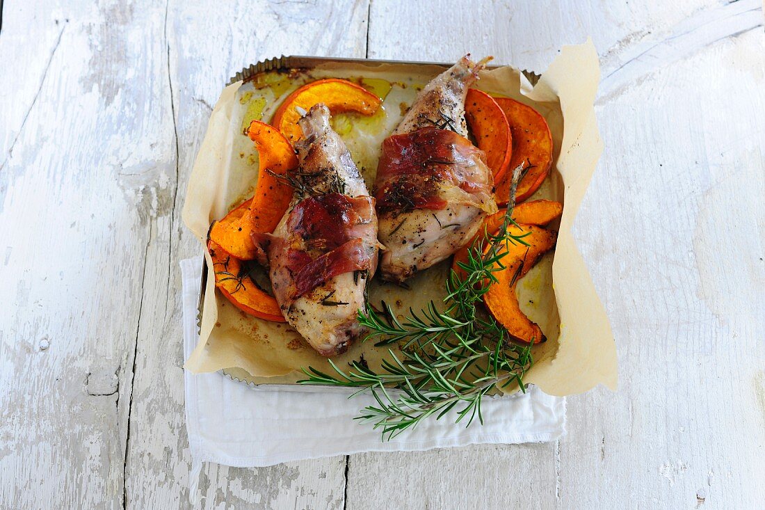 Rabbit wrapped in bacon with pumpkin and rosemary