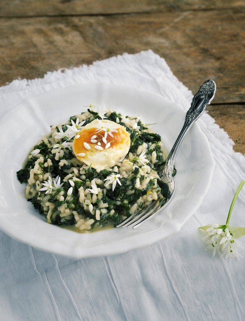 Wild garlic risotto on a white napkin on a wooden table