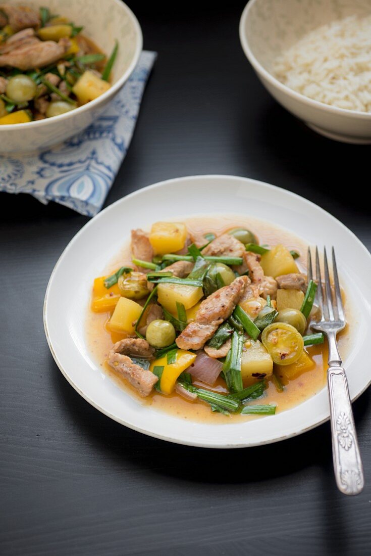 Pork with potatoes, beans, peppers and olives