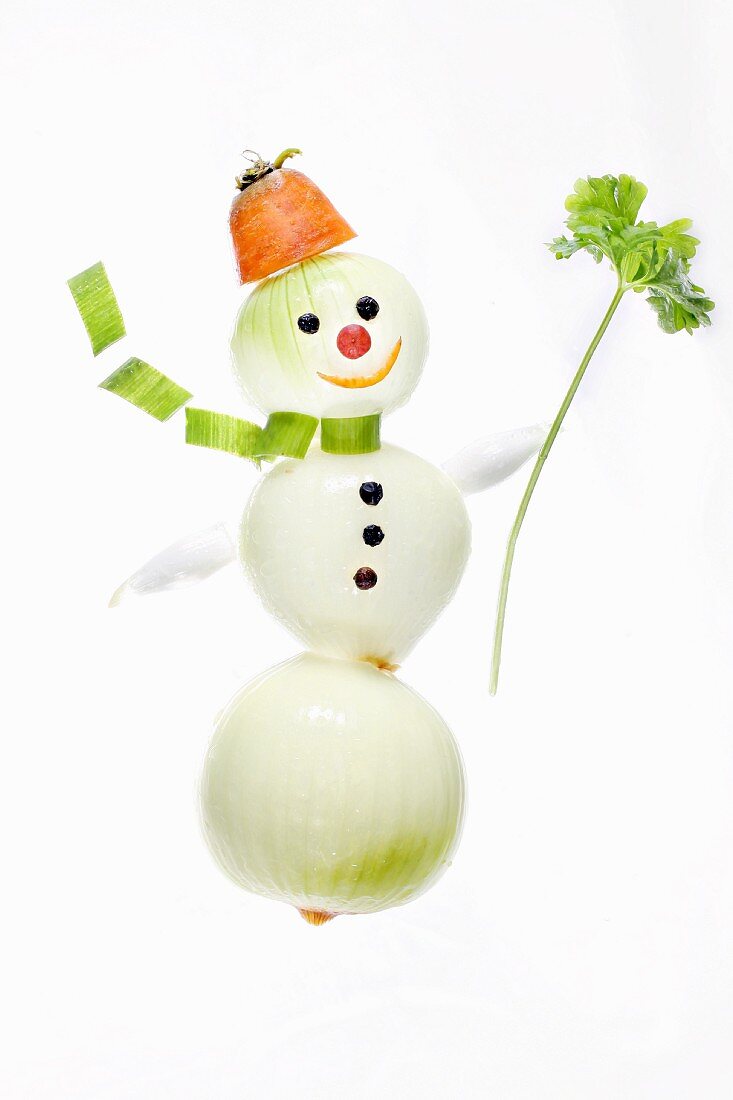 A snowman made from onions, carrots and parsley