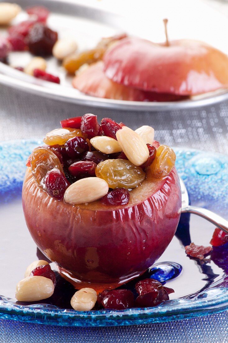 Baked apples stuffed with raisins, almonds and cranberries with honey