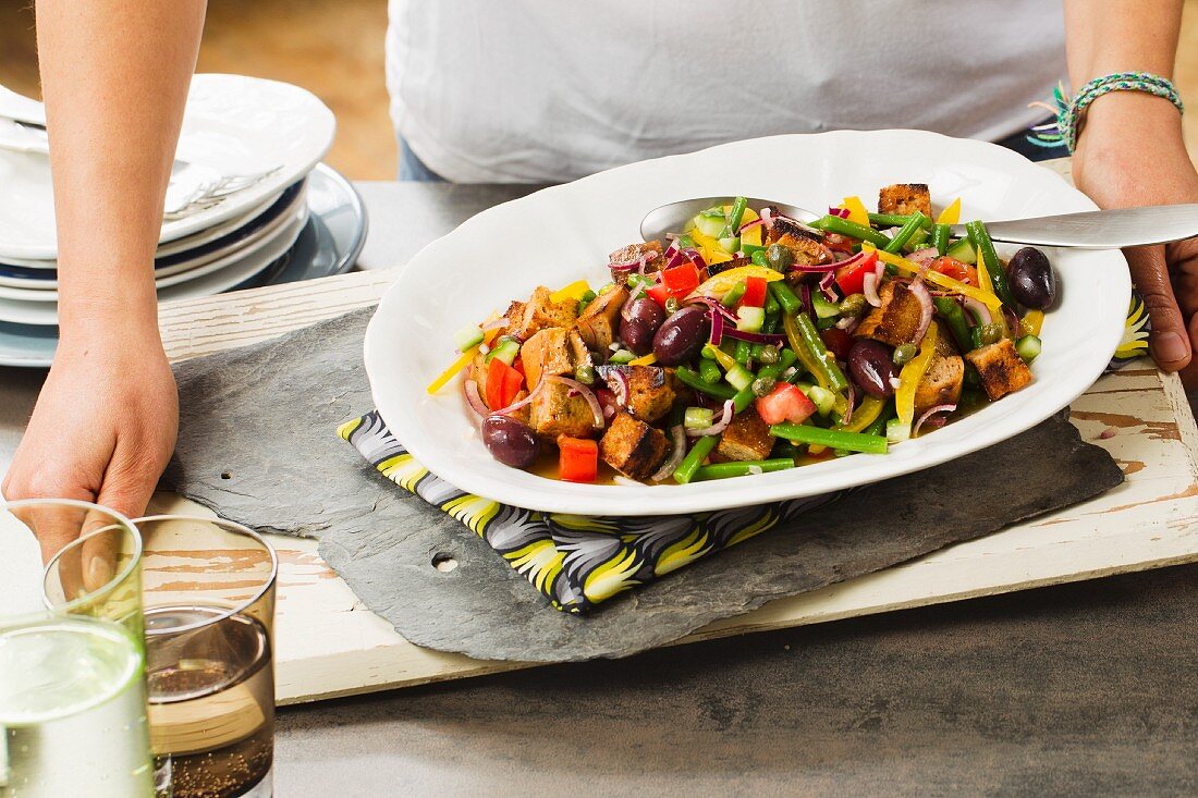 Bread salad with colourful vegetables, olives and capers
