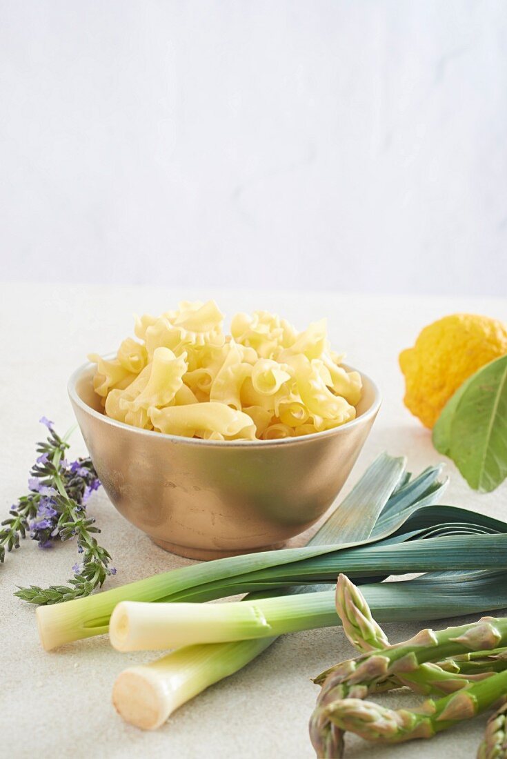 Ingredients for a pasta dish with asparagus, lemon, leek and lavender