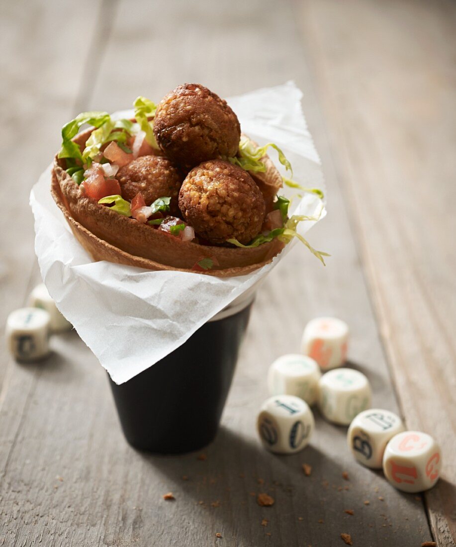 A wheat tortilla filled with vegan millet risotto balls as a takeaway