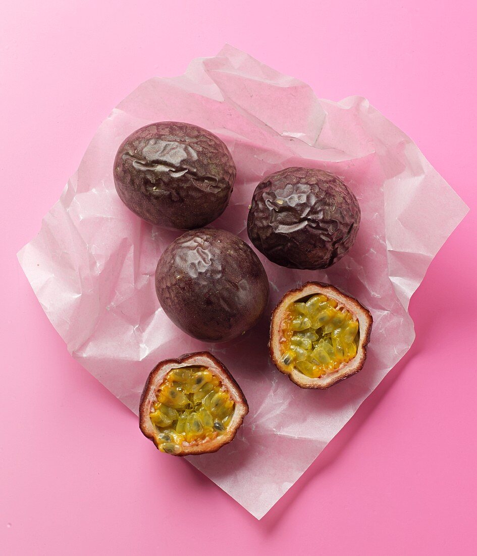Four passion fruits on a piece of paper
