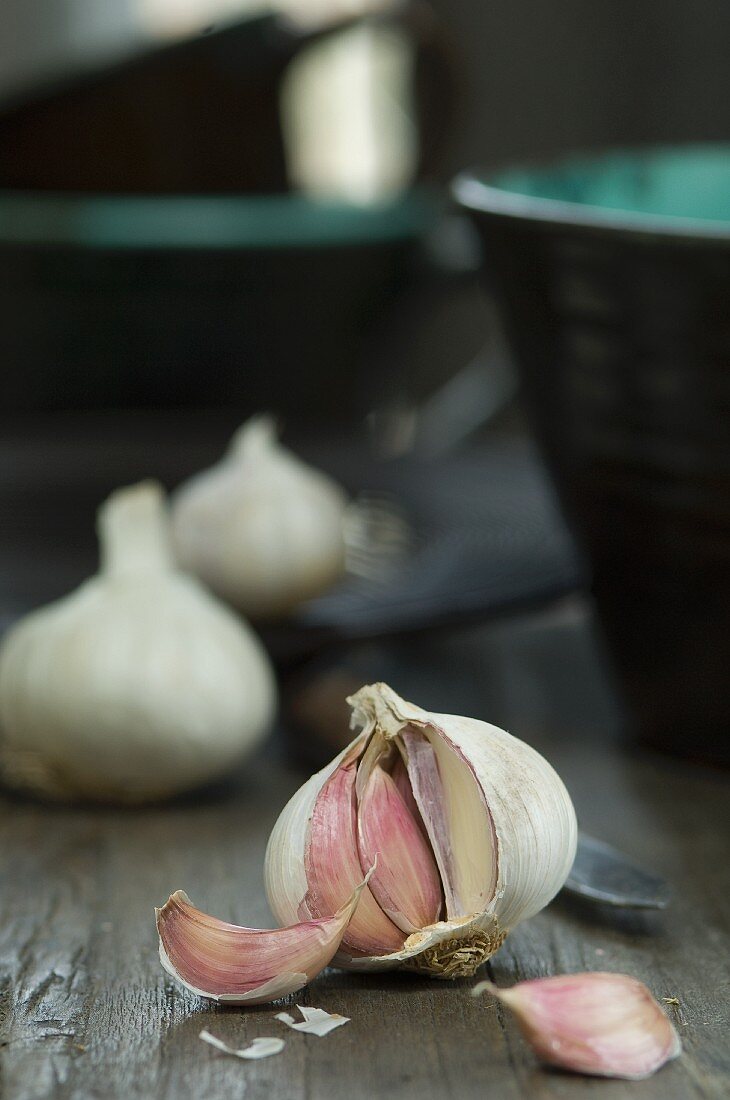 An open bulb of garlic on a wooden table