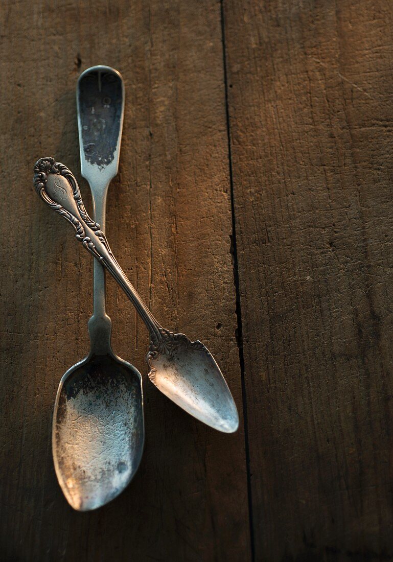 Old spoons on a wooden surface
