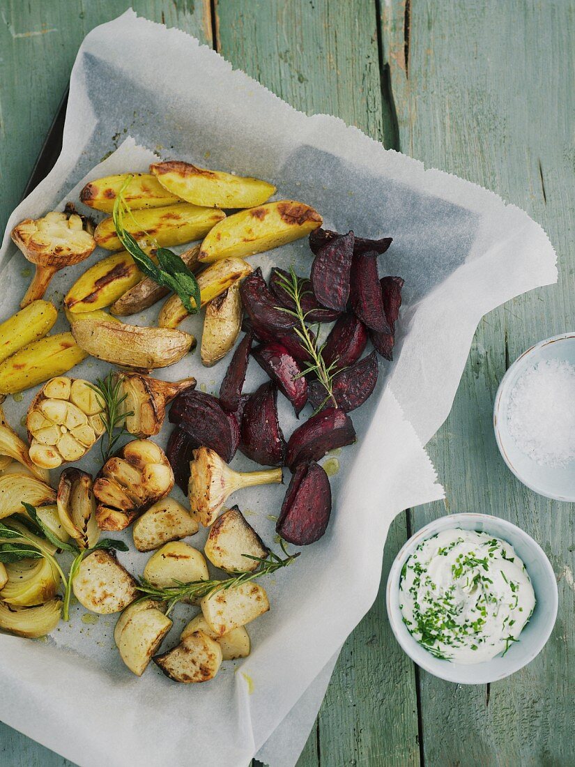 Oven-roasted vegetables with herb quark on a baking tray