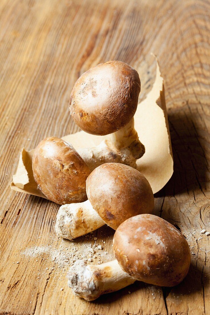 Fresh brown mushrooms on a wooden surface