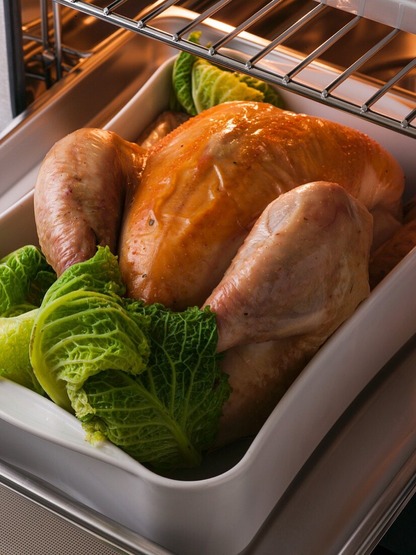 Roast chicken with savoy cabbage in the oven