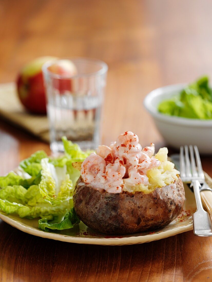 A baked potato filled with king prawns