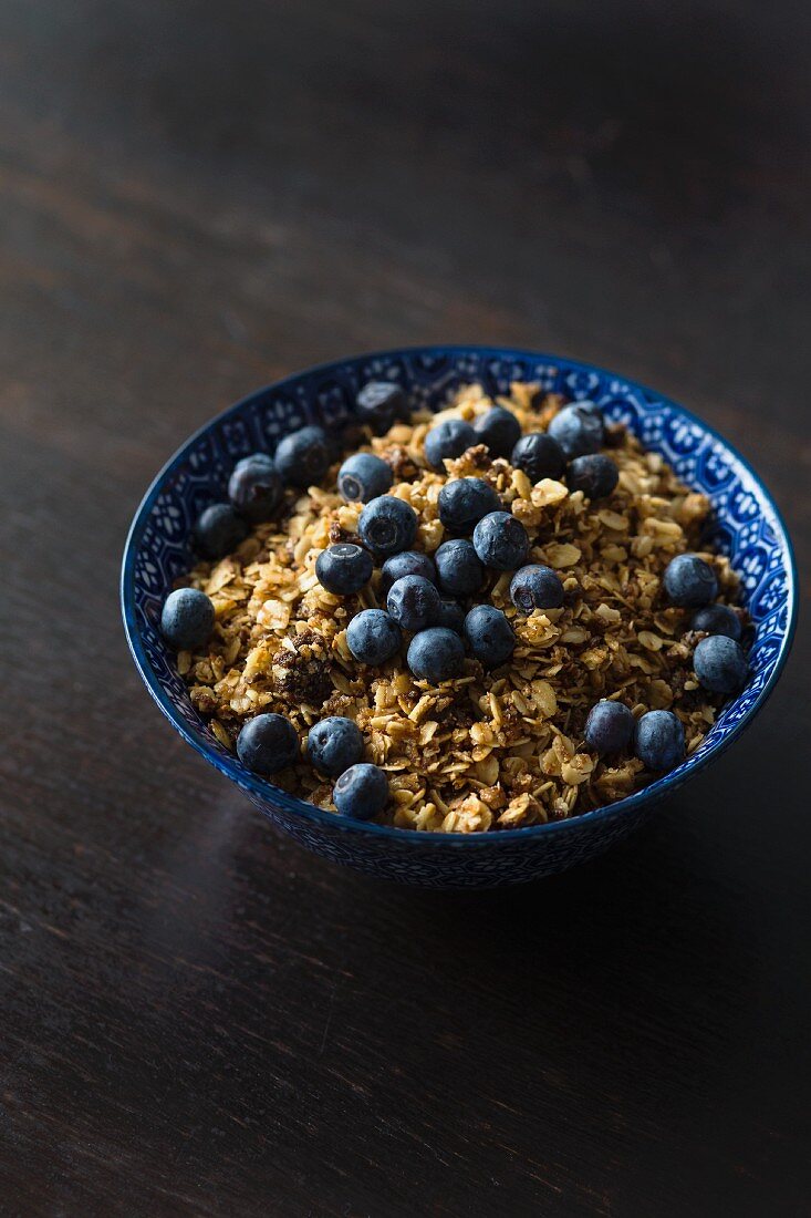 A bowl of muesli with fresh blueberries