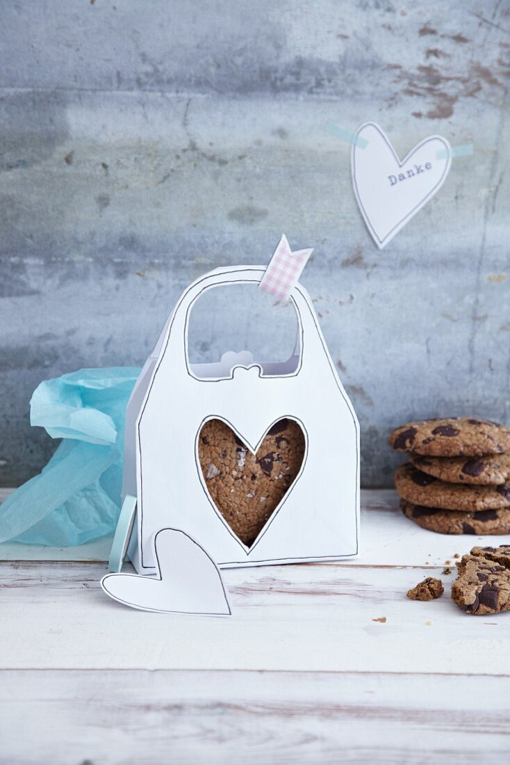 Chocolate chip cookies in a homemade, white paper handbag box