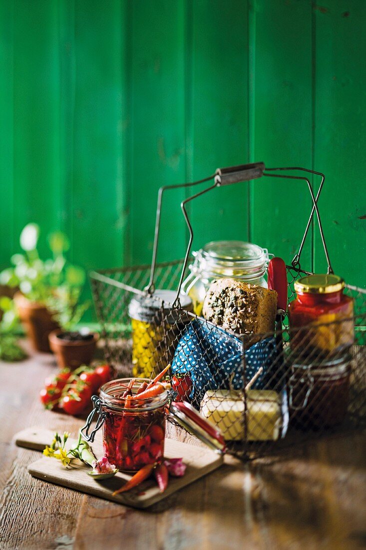 Arrangement of preserved vegetables, seeded bread and butter