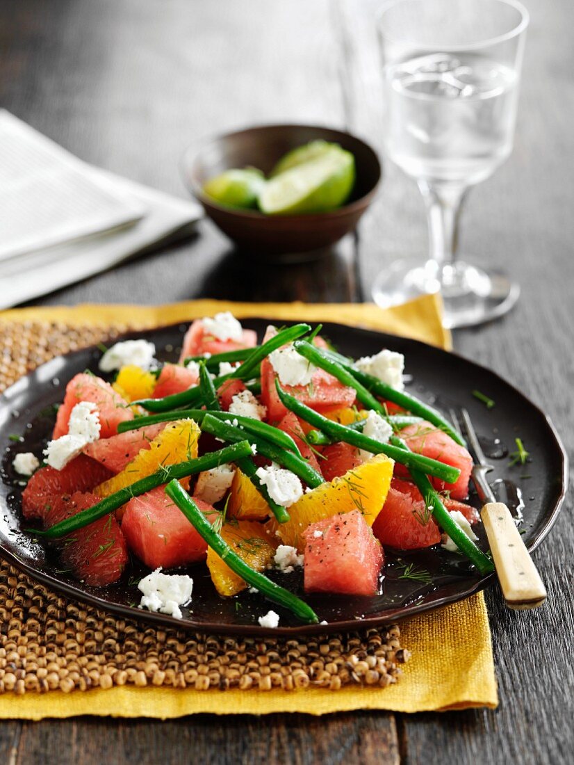 Watermelon salad with citrus fruits, green beans and feta cheese