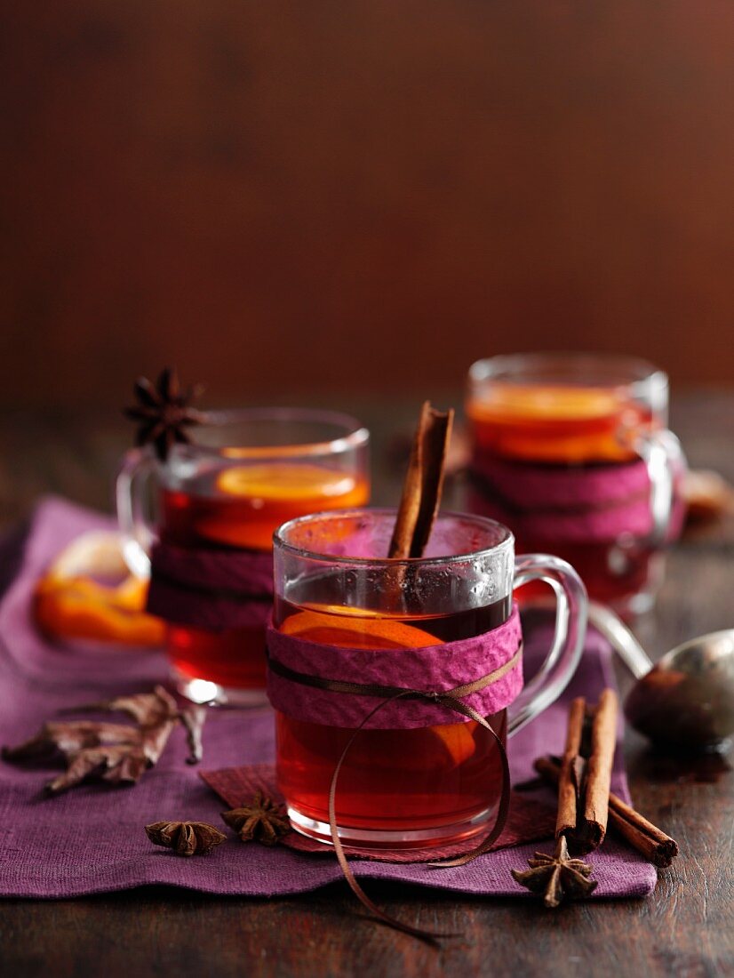 Glasses of mulled wine with cinnamon, anise and orange slices