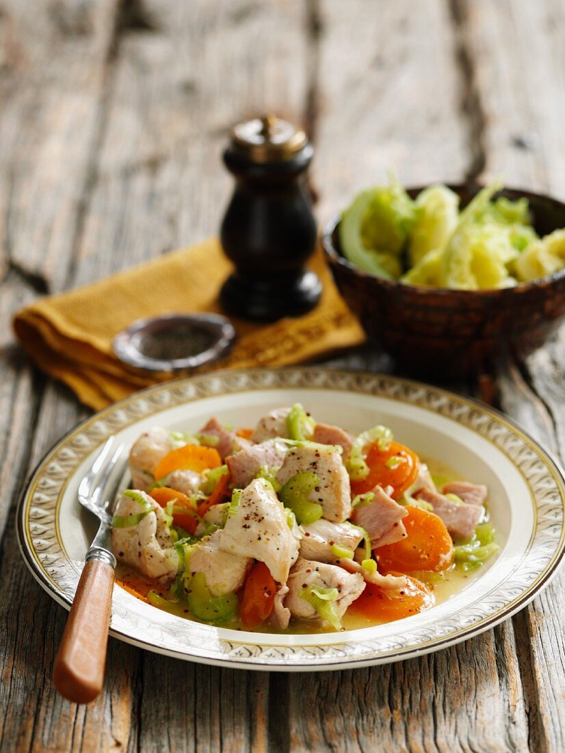 Chicken stew with ham, carrots, celery and mastered